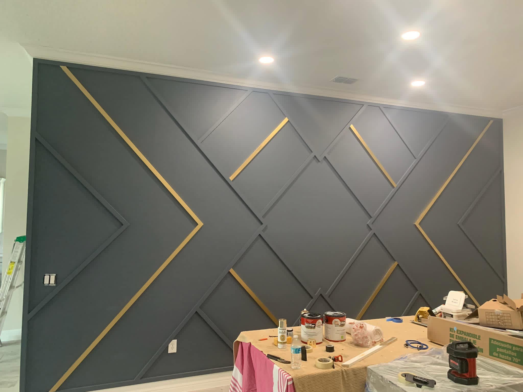 Geometric painted accent wall with gold trim